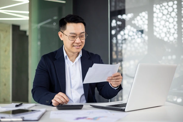 A man reviewing documents for Singapore income tax filing