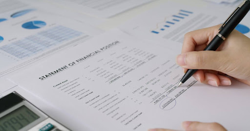 A person reviewing and signing a Statement of Financial Position document