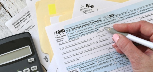 Tax filing forms and calculator on a desk representing IRAS corporate tax filing in Singapore