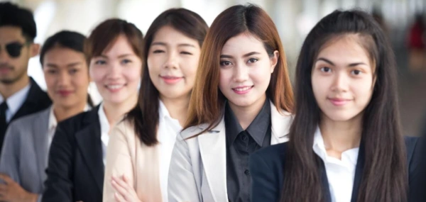 Business professionals standing together in an office corridor